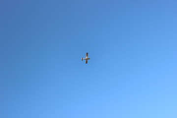 Fototapeta na wymiar Propeller airplane flying in the sky without clouds
