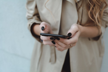 young pretty woman posing in the street with phone, outdoor portrait, hipster girls, sisters, chic, tablet, internet, using smartphone, close-up fashion model, post in instagram, facebook