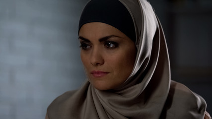Naklejka premium Unhappy female in hijab feeling hurt, sad eyes tears, depression, hopelessness