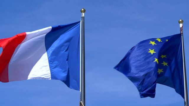 French and European Union EU Flags Blue Sky Slow Motion.