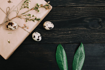  Rustic easter still life with quail eggs, dry willow branches on dark background. Flat lay, top view