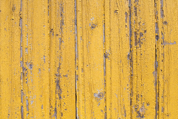 rustic wooden old flaked  yellow painted texture of planked wall pattern