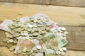 Coin and paper money turkish liras on white and wood background