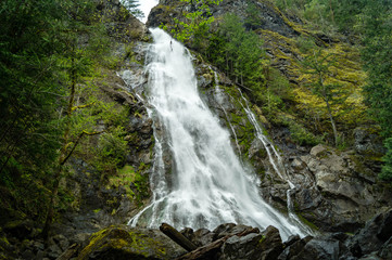 Fototapeta na wymiar Rocky Brook Falls flows out of the Olympic National Park near Brinnon, Washington on Washington's Olympic Peninsula