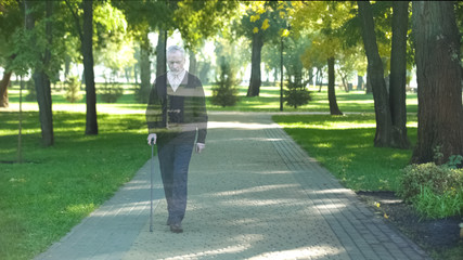 Mature grandfather walking in park and disappearing, death concept, loss