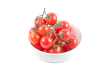 Fresh organic cherry tomatoes bunch on ceramic bowl isolated on white.