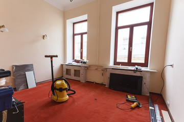 View on the room with vacuum cleaner and construction tools are in the hotel is under construction, remodeling, renovation, extension, restoration and reconstruction. Concept of hotel improvement or