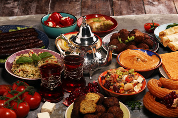 Middle eastern or arabic dishes and assorted meze, concrete rustic background. Falafel. Turkish Dessert Baklava with pistachio. Halal food. Lebanese cuisine