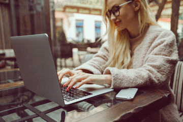Pretty Young Beauty Woman Using Laptop in cafe, outdoor portrait business woman, hipster style,...