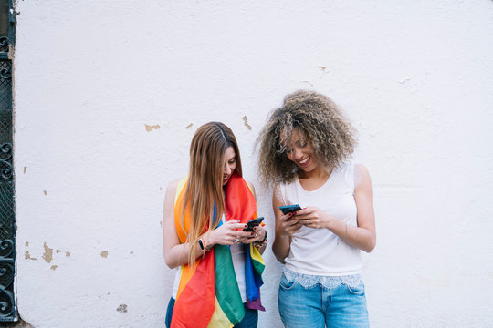 Beautiful women using a mobile in the Street.