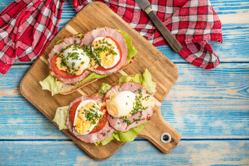 Sandwich with tomatoes, eggs and lettuce.