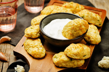 Baked cauliflower Tots on a wood background