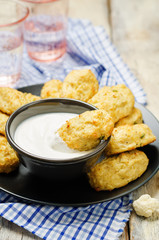 Baked cauliflower Tots on a wood background