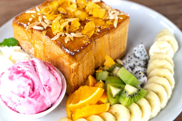 honey toast honey topped  with strawberry ice cream and mix fruit