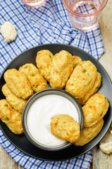 Baked cauliflower Tots on a wood background
