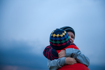 happy children playing in field sown with winter wheat against backdrop of rain clouds. Brothers...