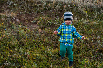 happy children playing in field sown with winter wheat against backdrop of rain clouds. Brothers...