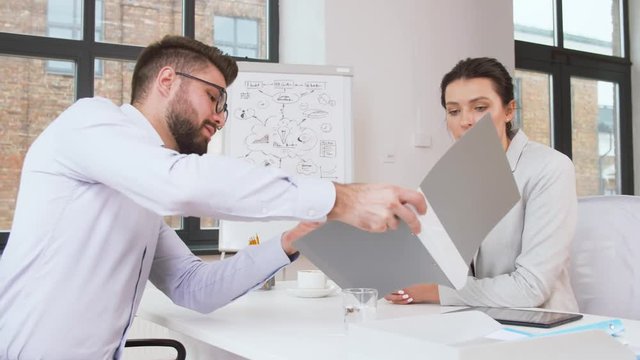 job, business and employment concept - female employer or hr manager having interview with male employee at office