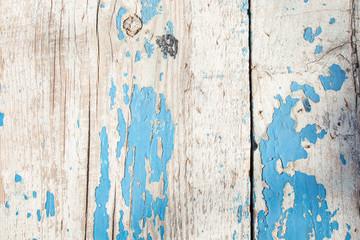 cracked horizontal wooden panel with peeling blue paint