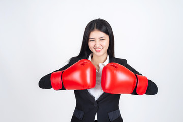 beautiful Asian business young woman  Wearing a boxing glove in hand and business suit , Winning success business woman concept