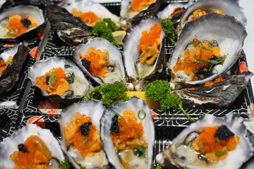 Dish of oysters stuffed with black and orange caviar