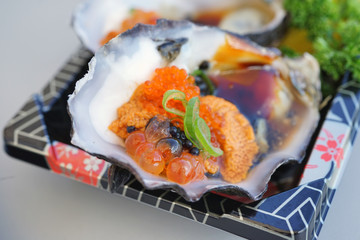 Dish of oysters stuffed with black and orange caviar