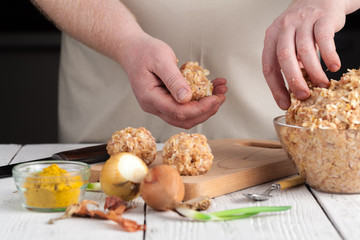 homemade meatballs with cheese, garlic and black pepper on the wooden chopping board