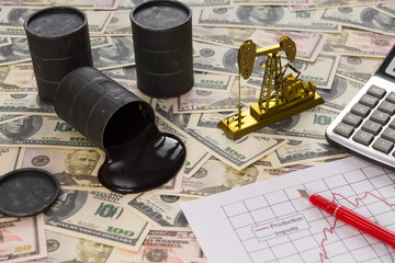 barrels with oil, a calculator, a neftechka, a schedule of sales, oil production against the background of American dollar bills. fuel industry, oil business.