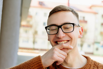 portrait of a guy in glasses and sweater. 