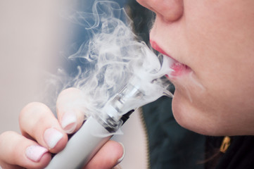 Closeup of mouth of woman with e-cigarette in outdoor - 262602430