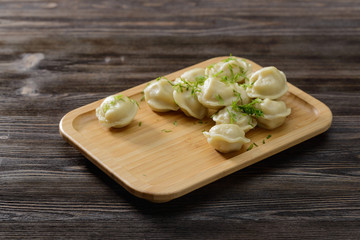 Hot dumplings with greens on a plate