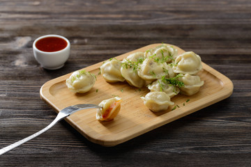 ravioli with sauce, herbs and pepper