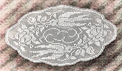 Handmade doily background texture grunge. Crocheted motive. Square tablecloth with flowers.