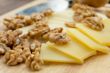 cheese and walnuts on a wooden Board,