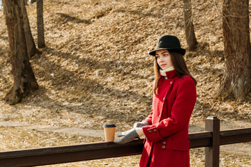 Young girl drinks coffee outside. Spring vibes