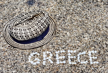 The word Greece made of shells on beach in the sand.
