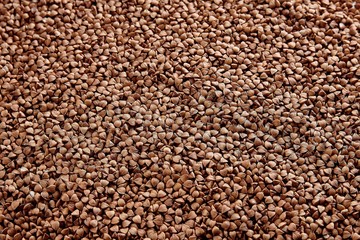 Textured background of natural buckwheat spread out on the table