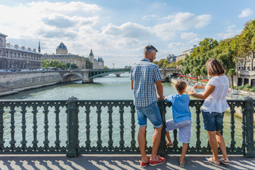 Happy family of three enjoying vacation in Paris, France