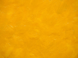 The cement wall is painted bright yellow.
