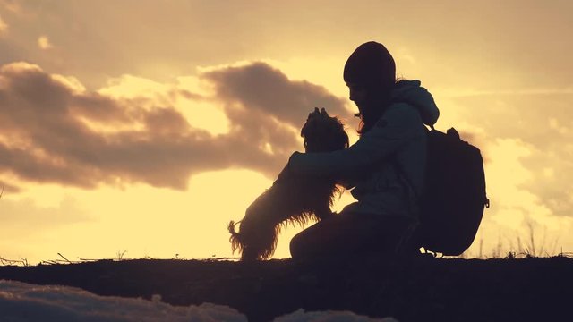 little girl daughter and dog teamwork happy family tourists silhouette concept holding hands spinning funny video. happy childhood. girl and dog team friendship and care with pets sunset play dabble