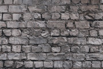 Old stone wall background. Brick wall background. Grey textured concrete wall. Rough texture rock. Concrete grunge background of cement construction material. 