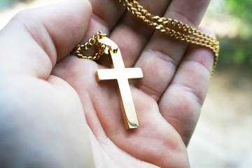 Religious Golden Cross In Palm Of Hand High Quality 