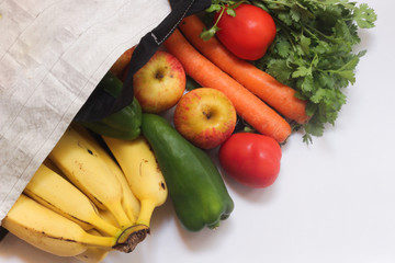 Eco natural bags, Grocery food shopping bag with fruits and vegetables. Concept plastic free items. reuse, reduce, recycle, refuse, sustainability. Copy space in white background.