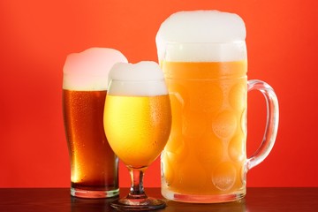 Golden beer in glass with foam, alcohol beverage,  full.