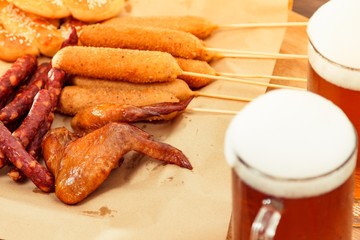 Beer glass alcohol drink with food sausage,  pub dinner.