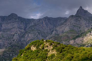 The majestic mountain and a small church on a cloudy day  (region Tzoumerka, Epirus, Greece)
