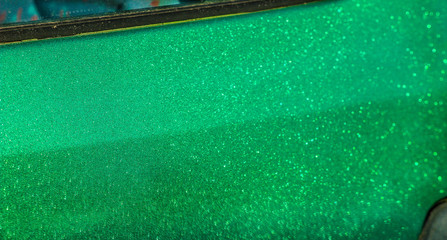 green paint car body film with sparkles shimmers in the sun.