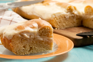 Sliced piece of apple pie with sour cream on a plate - photo, image