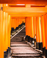 Orange gates and objects at Fushimi Inari-Taisha Shrine in Kyoto, Japan