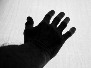 Black hand Silhouette of a human hand raised up.